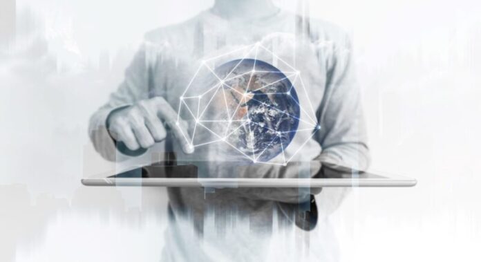 Business professional using a tablet to interact with a connected digital globe, representing global technology, data intelligence, digital transformation and enterprise connectivity.