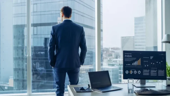 Business leader reviewing revenue analytics and performance data in a modern office.